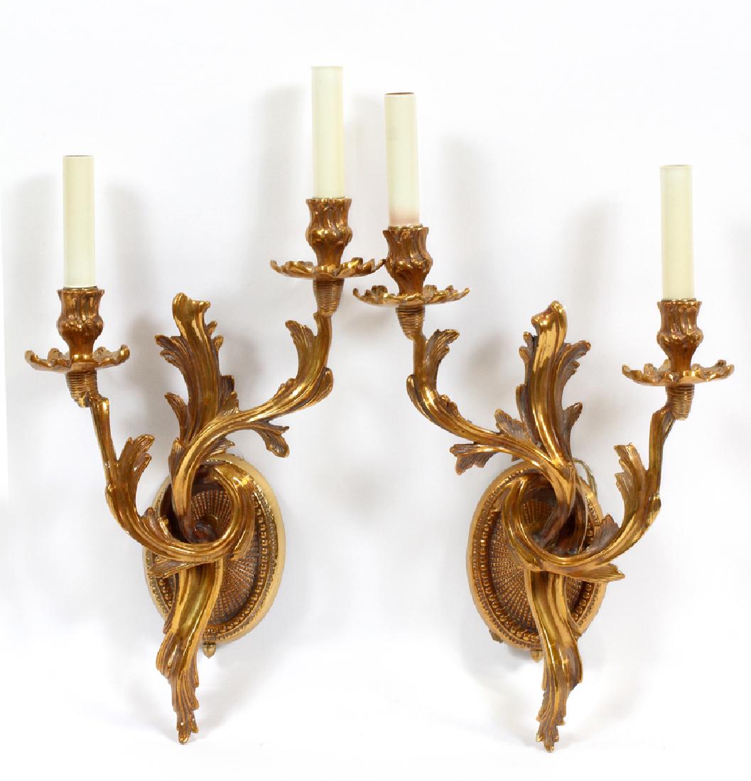 FREDERICK COOPER TWO-LIGHT BRASS SCONCES: FREDERICK COOPER TWO-LIGHT BRASS SCONCES, PAIR, H 18.5", W 11" :Having a scrolling leaf design, electrified. Having a Frederick Cooper label on the verso.