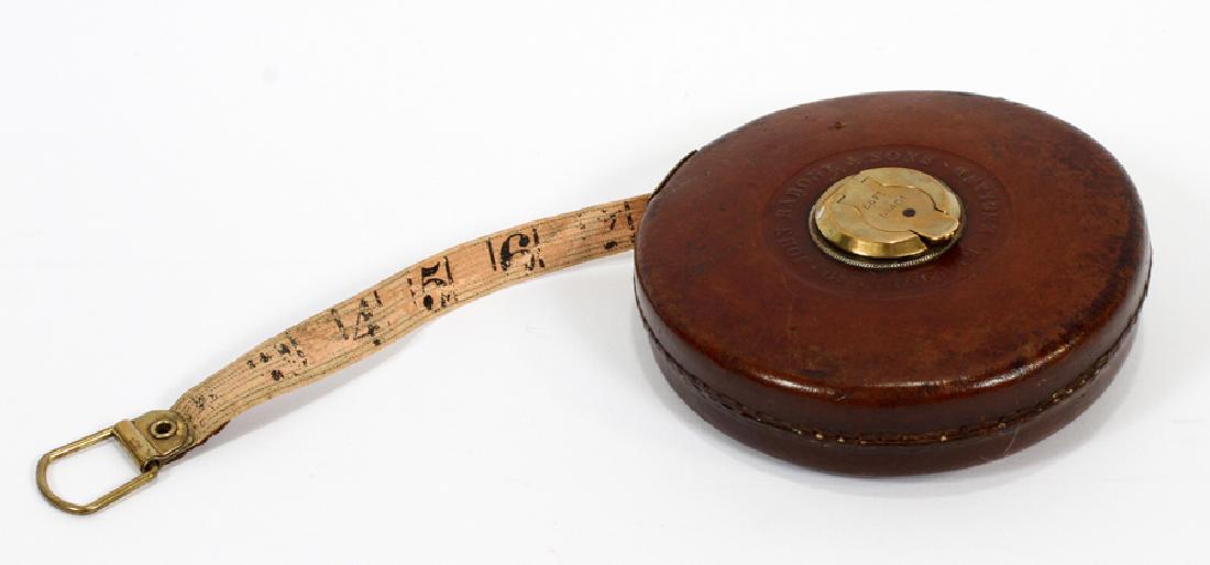 JOHN RABONE & SONS 'METALLIC WIRED TAPE': JOHN RABONE & SONS 'METALLIC WIRED TAPE', CA. 1910, D 1", DIA 5" :An antique measuring tape manufactured by John Rabone & Sons of Birmingham, England. This piece offers sixty-six feet of tape and is n
