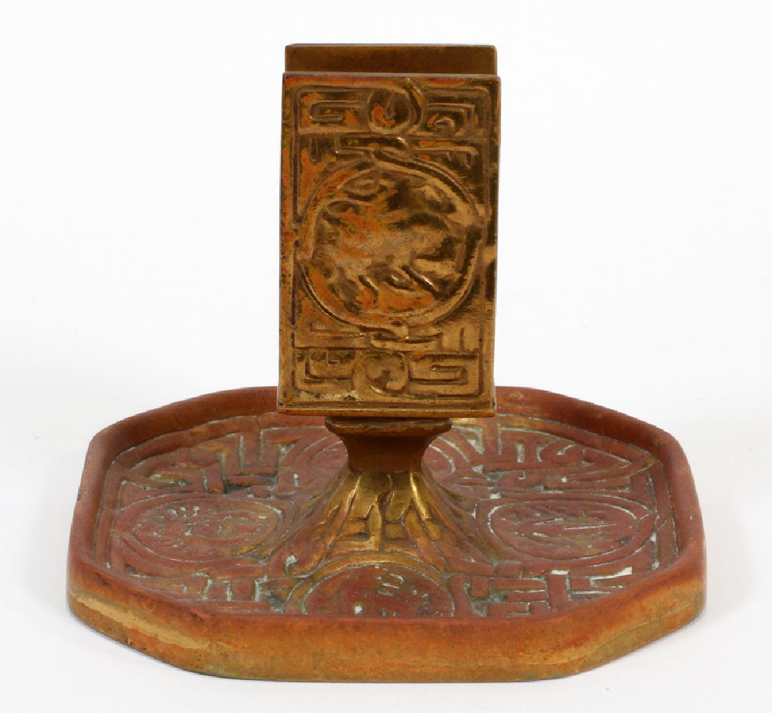 TIFFANY STUDIOS BRONZE MATCHBOX HOLDER & ASHTRAY: TIFFANY STUDIOS, BRONZE "ZODIAC" MATCHBOX HOLDER AND ASHTRAY H 4", W 4 3/4" :#1041.