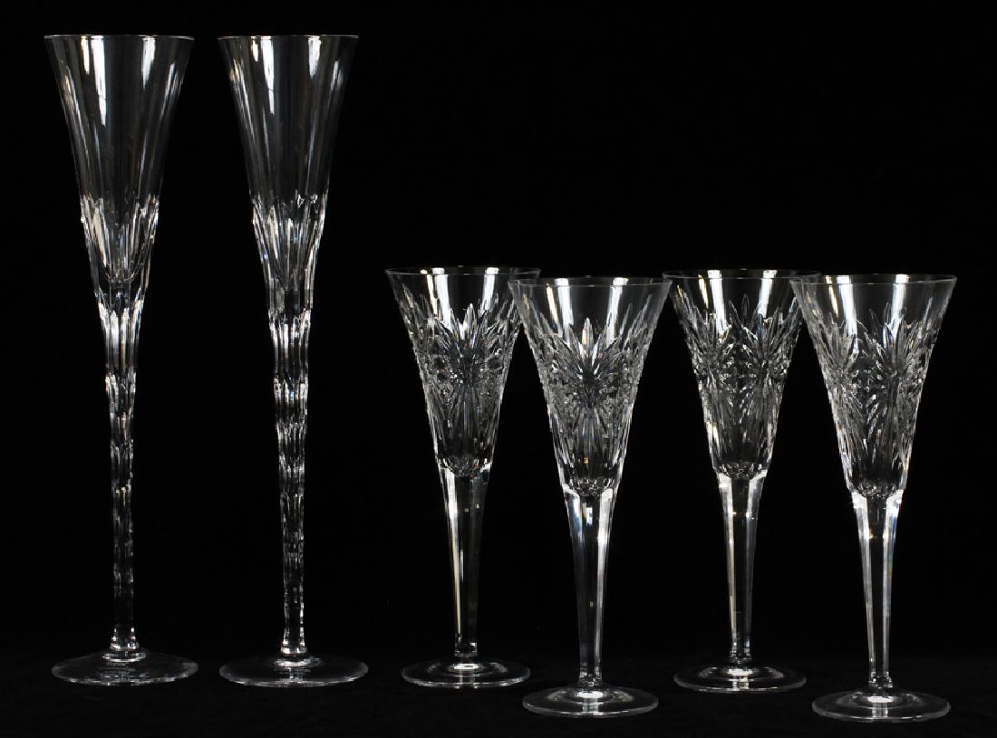 CRYSTAL MILLENNIUM FLUTES & WATERFORD FLUTES: CRYSTAL MILLENNIUM FLUTES & WATERFORD FLUTES, 6 PCS H 14", 9.5" :Includes: pair of crystal millennium flutes 14", Ingrid Collection, "Diamond Inspired". Four Waterford crystal flutes H 9.5".