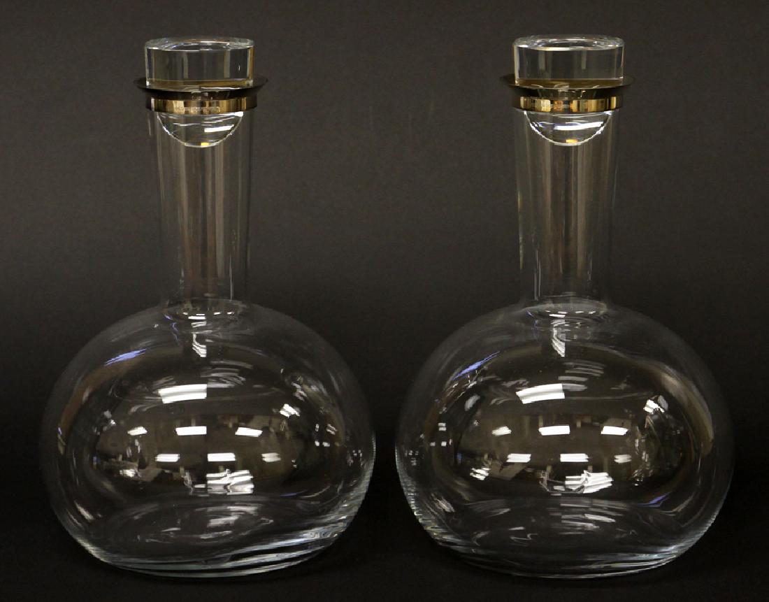 GEORG JENSEN, OLE PALSBY GLASS & SILVER DECANTERS: GEORG JENSEN, OLE PALSBY GLASS & SILVER DECANTERS, PAIR, H 9", DIA 6":A pair of Ole Palsby glass decanters featuring George Jensen sterling silver. Each piece offers a fitted glass lid, a narrow neck 