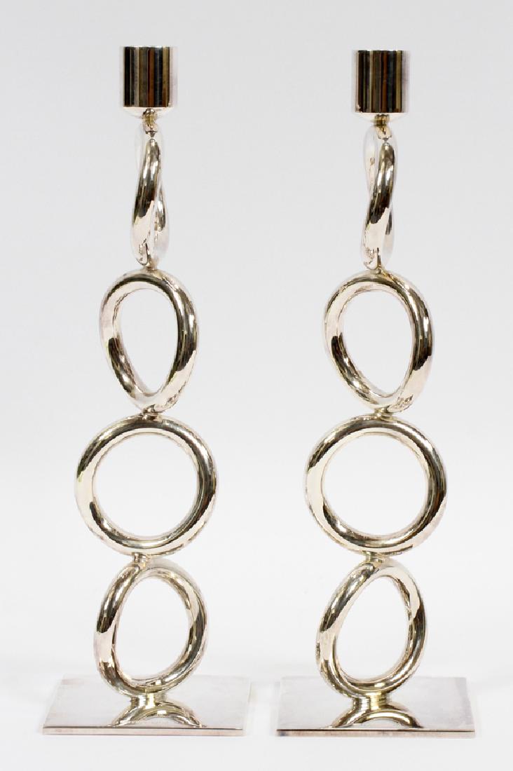 CHRISTOFLE 'VERTIGO' SILVER PLATE CANDLESTICKS: CHRISTOFLE 'VERTIGO' SILVER PLATE CANDLESTICK HOLDERS, PAIR, H 11.5", W 3.25", D 3.25":A pair of Christofle silver plate candlestick holders, having the 'Vertigo' style. The 'Vertigo' style was design