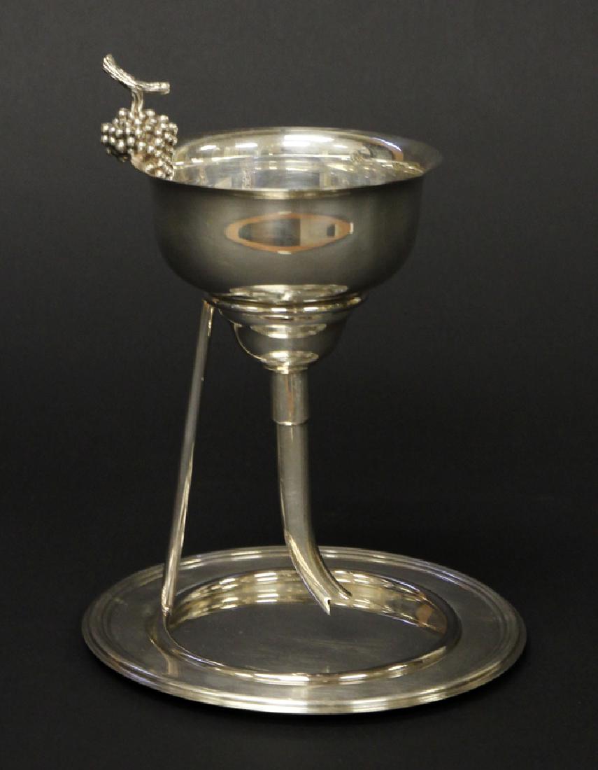 ERCUIS SILVER PLATE WINE FUNNEL, H 7", DIA 5": ERCUIS SILVER PLATE WINE FUNNEL, H 7", DIA 5":An Ercuis silver plate wine funnel. This piece features a grape cluster to the rim of the basin, a fitted strainer and funnel to filter abnormalities pres