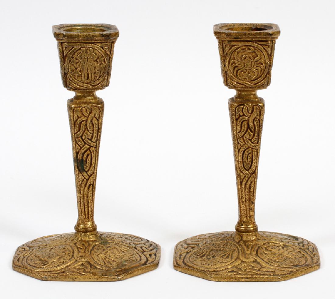 TIFFANY STUDIOS GILT BRONZE CANDLE STICKS: TIFFANY STUDIOS, NEW YORK, ZODIAC, GILT BRONZE, CANDLE STICKS, C. 1900, H 5.5", DIA 3.5", 1207 Gilt bronze, single light, candle sticks with zodiac signs, incised "Tiffany Studios New York 1207" on bo