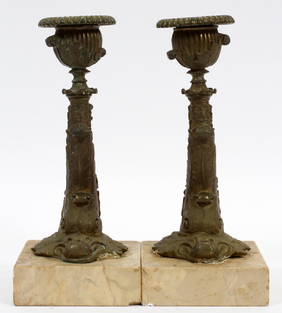 BRONZE & MARBLE CANDLE HOLDERS, PAIR: BRONZE & MARBLE CANDLE HOLDERS, PAIR, H 7", DIA 3 3/4" Single light. Dolphin form candle stick and a white marble base.
