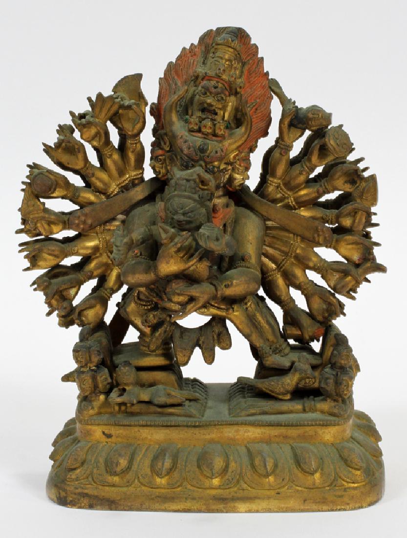 TIBETAN MAHAKALA GOD BRONZE STATUE H 7" W 5": TIBETAN MAHAKALA GOD BRONZE STATUE H 7" W 5" Bronze statue depicting the Tibetan Buddhist god Mahakala, who has multiple arms and clutches a figure, which is loose and can be lifted. Researcher's numb