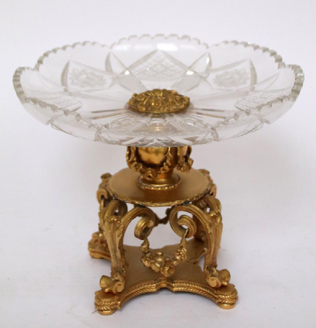 CRYSTAL & BRONZE CENTERPIECE COMPOTE & BOWL: FRENCH STYLE CRYSTAL & BRONZE CENTERPIECE COMPOTE & BOWL, H 9", DIA 11 1/4" D'ore bronze base, scrolling leaf with floral swag at base. Cut crystal bowl.