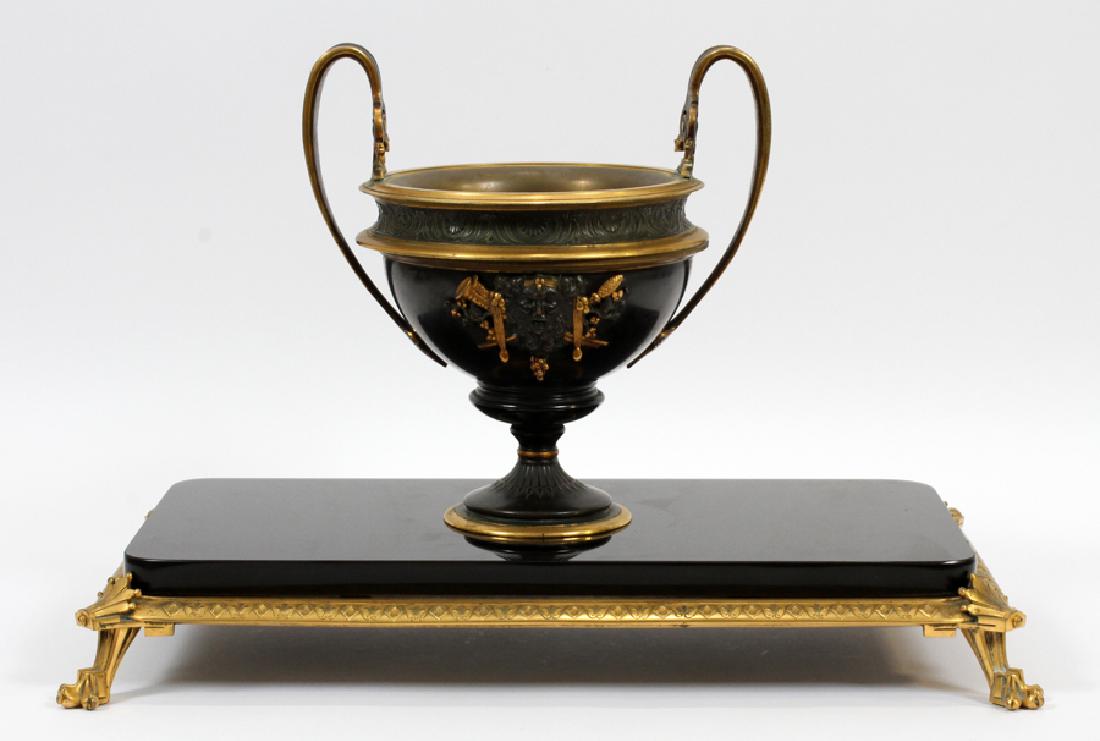 FRENCH STYLE BRONZE & MARBLE COMPOTE: FRENCH STYLE, TWO-TONE BRONZE & MARBLE COMPOTE WITH LOWER PLATEAU, MODERN, H 9 3/4", W 10 1/4", L 18 1/2" On a bronze and black onyx plateau, H 2 3/4".