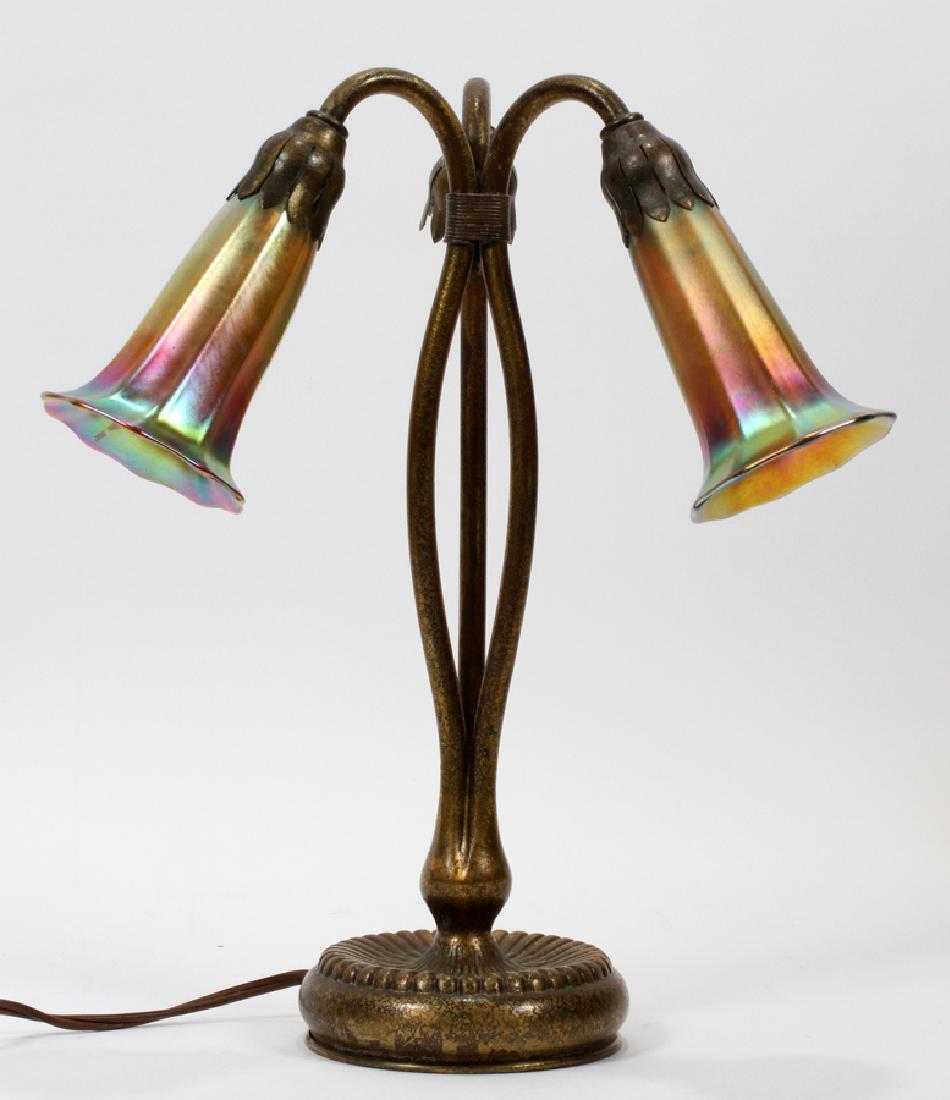 TIFFANY STUDIOS, NY, BRONZE 3-LIGHT LILY LAMP: TIFFANY STUDIOS, NY, BRONZE 3-LIGHT LILY LAMP, H 13" DIA 6 1/2"A Tiffany Studios New York bronze 3-Light Lily lamp. This piece features three porcelain light sockets and a rotating electric switch acc