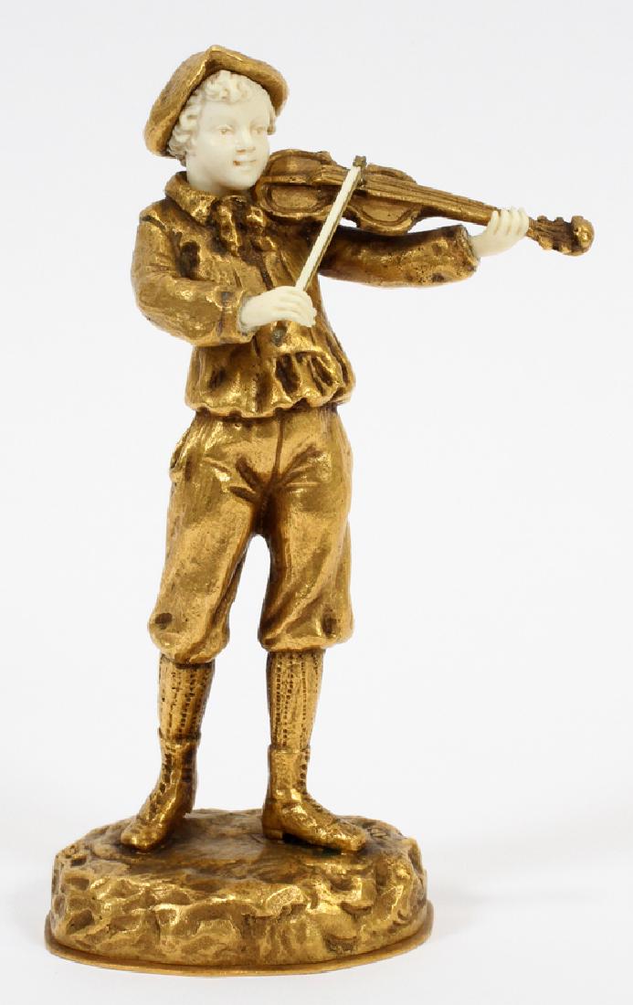 OSTREM BRONZE VIOLINIST FIGURE, 20TH C.: OSTREM, BRONZE VIOLINIST FIGURE, 20TH C., H 7.5", W 3" Bronze dore figure of a youth playing a violin. Signed Ostrem. Measuring approximately 7.5" tall with a 3" width.