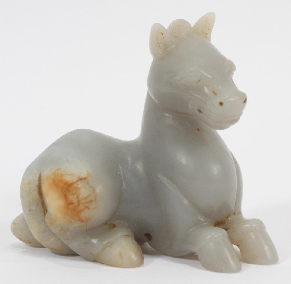 CHINESE LIGHT JADE RECUMBENT HORSE H 3" W 3.5": CHINESE LIGHT JADE RECUMBENT HORSE H 3" W 3.5" Hand carved Chinese recumbent horse. Light jade, with brown vein running through haunches and tail. Grey-ish color. Measuring approximately 3.5" tall and