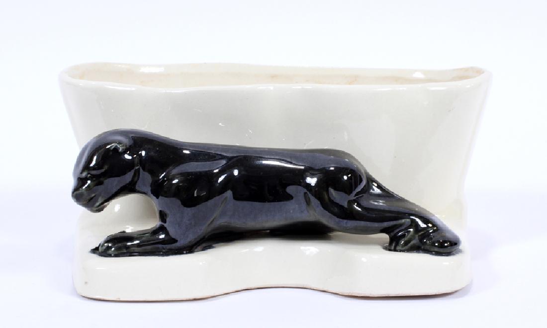 R.R.P. CO., AMERICAN ART POTTERY, PLANTER: R.R.P. CO., AMERICAN ART POTTERY, PLANTER, H 3.5", W 8", D 6.75":A R.R.P. Co American art pottery planter. This piece features a deep basin adjacent to a black panther motif. Signature branding to the