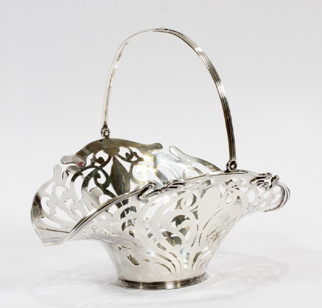 MAUSER MFG. CO. STERLING BASKET C. 1900 L 9.5": MAUSER MFG. CO. STERLING BASKET C. 1900 L 9.5" :.Height 5" with handle down, 8" handle raised. Monogram. Total weight: 10.60 troy ounces. From an important Sandringham Way, Bloomfield Hills estate,