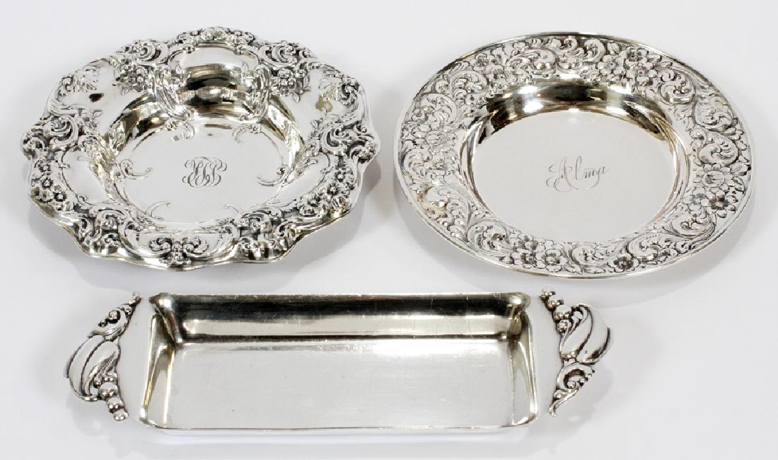 STERLING DISHES THREE DIA 3" - 7": STERLING DISHES THREE DIA 3" - 7" :T. A. Kohn sterling flat dish, engraved "Alma" 5.5", sterling butter dish by Webster Co., 7.7", sterling condiment dish by Montgomery Bros with repousse border 3.7".