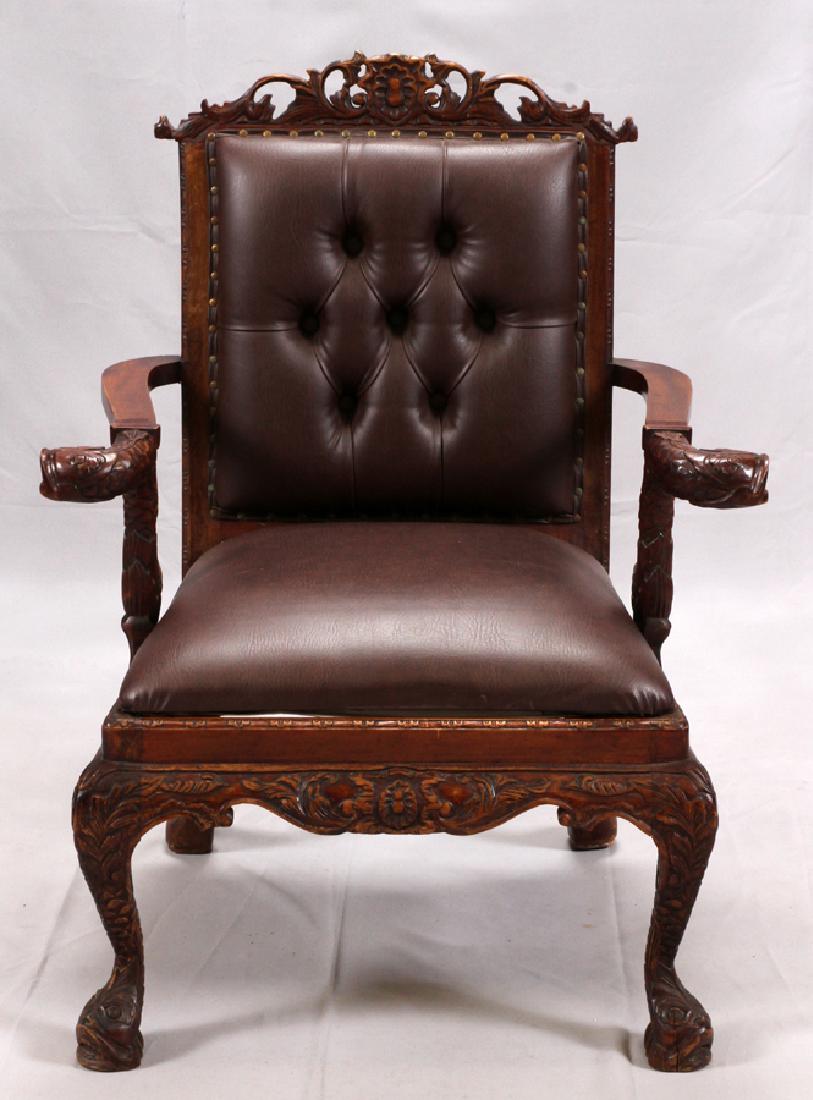 CARVED MAHOGANY OPEN ARM CHAIR, H 41.5", W 27.5": CARVED MAHOGANY OPEN ARM CHAIR, H 41.5", W 27.5" :Having dolphin form arms, faux leather seat and back, and pierced design at the top of the back.