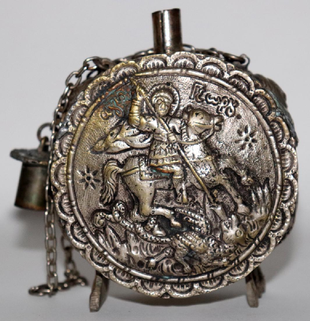 GREEK METAL FLASK, H 4", W 3 1/4", D 1 1/2": GREEK METAL FLASK, H 4", W 3 1/4", D 1 1/2":A soldered metal flask from Greece. This piece depicts a classical scene to either side--a ecclesiastic equestrian figure spearing a mythological creature. 