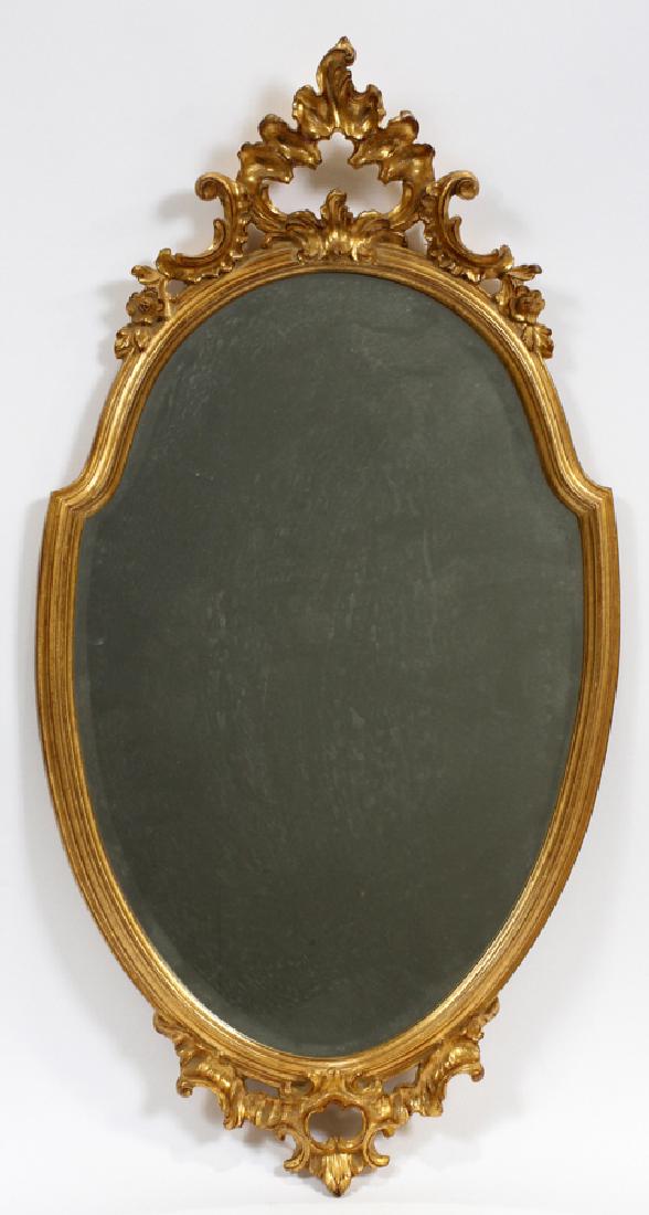 ROCOCO INFLUENCE SHIELD FORM MIRROR H 33" DIA 18": ROCOCO INFLUENCE SHIELD FORM MIRROR H 33" DIA 18" :Rococo influence shield form mirror. Having a decorative gilt frame with a floral and acanthus leaf motif. Modern. Measuring approximately 33" tall w