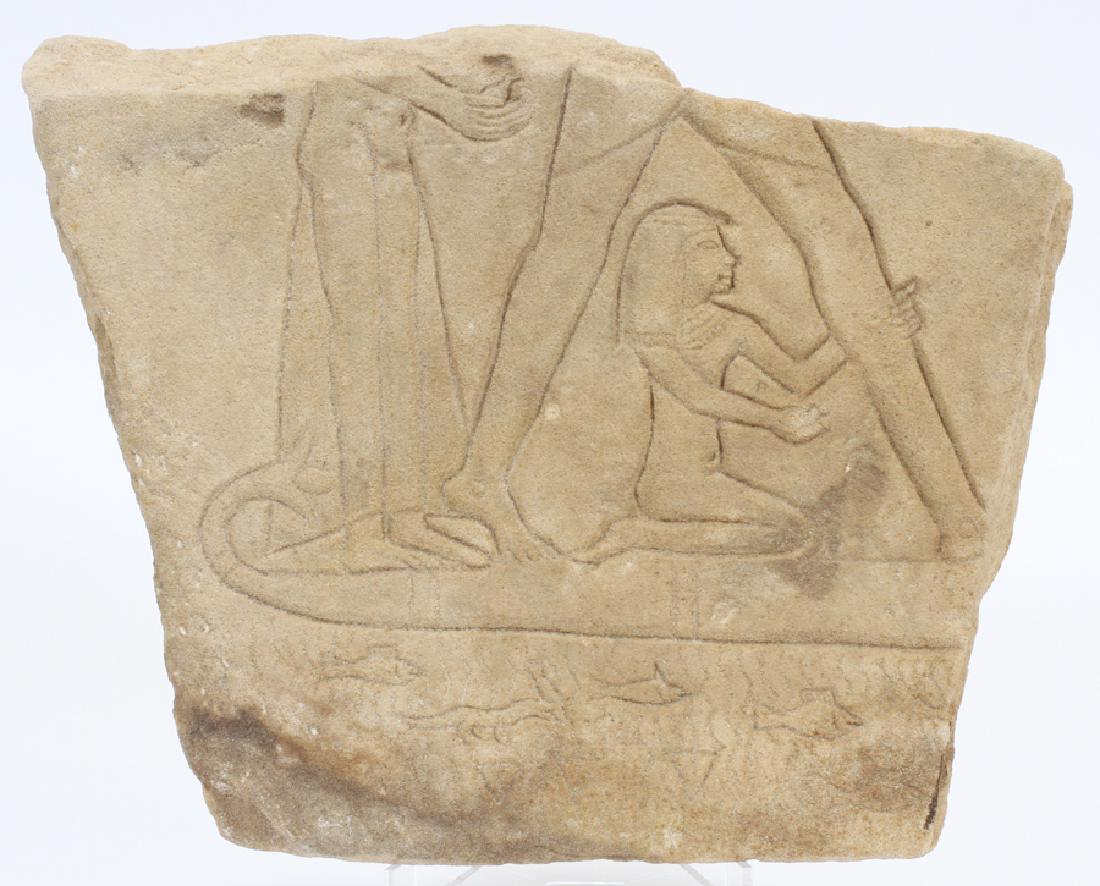 ANCIENT EGYPTIAN STYLE HIEROGLYPH FRAGMENT: ANCIENT EGYPTIAN STYLE HIEROGLYPH FRAGMENT, H 9.75", W 12.5", D 3":A sandstone fragment of an Ancient Egyptian style hieroglyph. This work features relief carvings of figures sailing on a papyrus boat