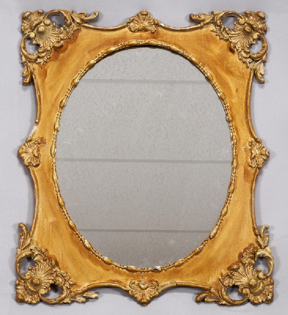ROCOCO INFLUENCE WOOD AND GESSO MIRROR: ROCOCO INFLUENCE WOOD AND GESSO MIRROR H 26" W 22" :A Rococo influence wood and gesso gilt mirror. Having a shell and acanthus leaf motif surrounding an oval opening.