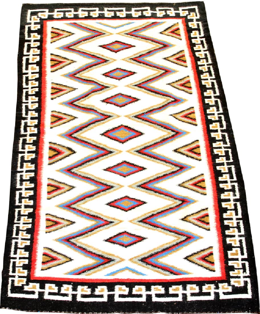 NATIVE AMERICAN, HAND WOVEN BLANKET: NATIVE AMERICAN, HAND WOVEN BLANKET, W 3' 7", L 5' 10" :A geometric hand woven Native American blanket. Having a black border with an ivory field and a central pattern of diamonds. Property of Robert 