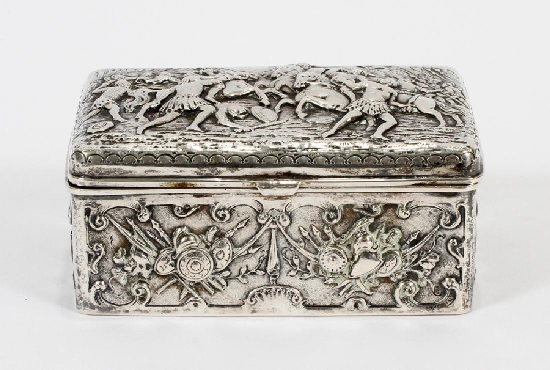 REPOUSSE STERLING HINGED BOX, H 2.5", W 4", L 6": REPOUSSE STERLING HINGED BOX, H 2.5", W 4", L 6" :A sterling repousse box depicting a detailed battle scene, with soldiers on horseback amidst weapons and shields. Vermeil interior. Weighing 12.02 Tro