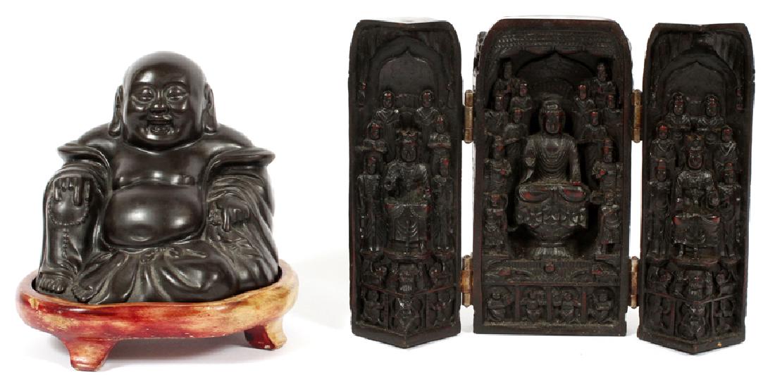 TWO CARVED COMPOSITE BUDDHIST ARTICLES: TWO CARVED COMPOSITE BUDDHIST ARTICLES, 20TH C., H 4 1/4"-6 1/2" :Comprising an carved composite wood example of a Budai, depicted as a traditional happy or laughing Buddha, seated and holding a stran