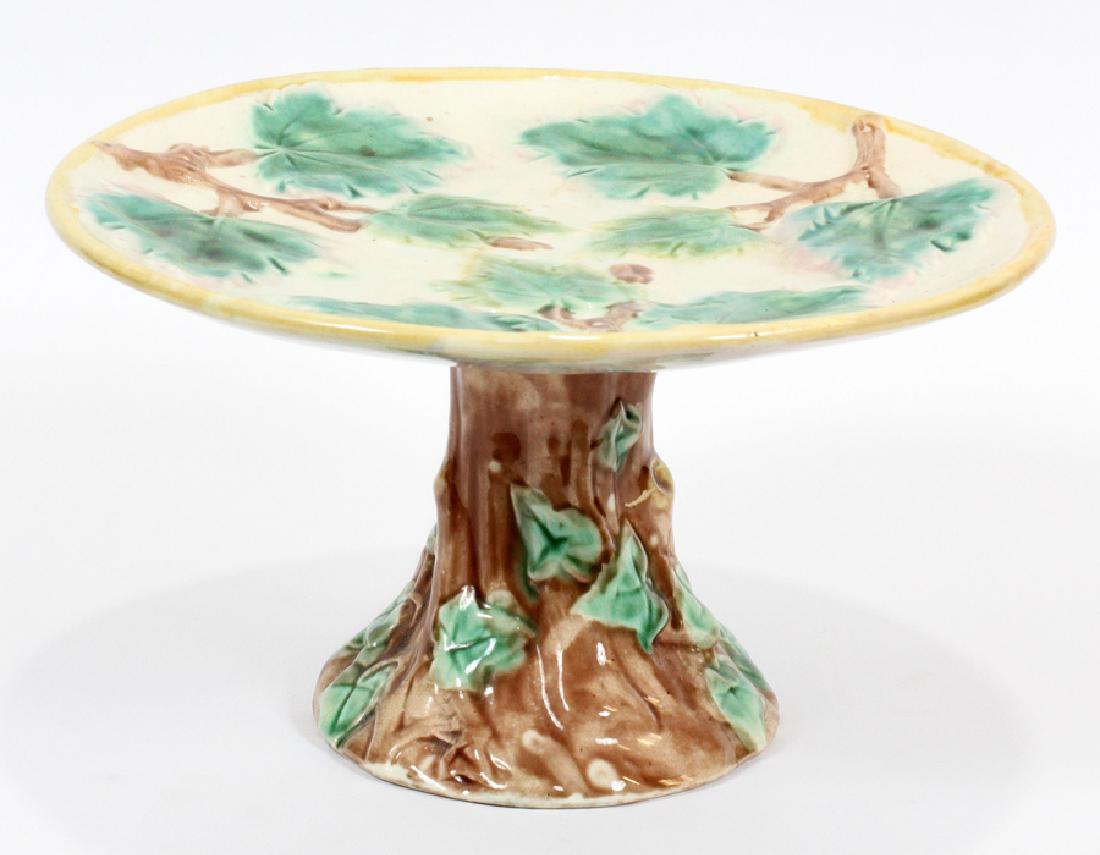 MAJOLICA POTTERY CAKE STAND, H 5.25": MAJOLICA POTTERY CAKE STAND, H 5.25", DIA 9", MAPLE TREE :A majolica cake stand. Depicting a maple tree with a trunk base and leaf motif to the basin. Maker's marks to the underside.