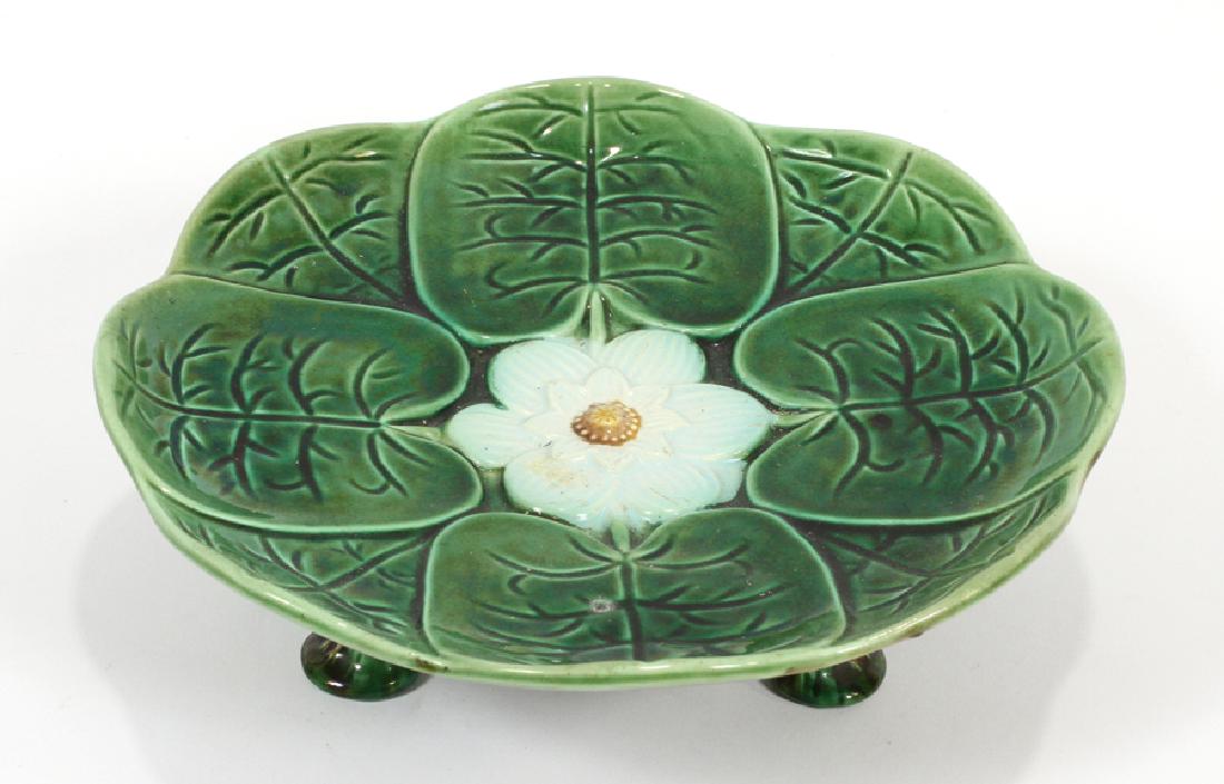 MAJOLICA POTTERY CAKE STAND, 20TH C., H 3": MAJOLICA POTTERY CAKE STAND, 20TH C., H 3", DIA 9", LILY PAD :A vintage majolica cake stand. Having a tri-footed base and lily pad motif central basin. No apparent maker's marks to the underside.
