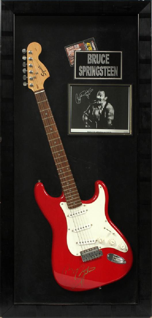 BRUCE SPRINGSTEEN AUTOGRAPHED FENDER GUITAR: BRUCE SPRINGSTEEN AUTOGRAPHED 'SQUIRE STRAT' FENDER GUITAR, AND BLACK AND WHITE PHOTO, H 48", W 23":Includes one Bruce Springsteen autographed, red bodied, 'Squire Strat' Fender guitar, signed in gold