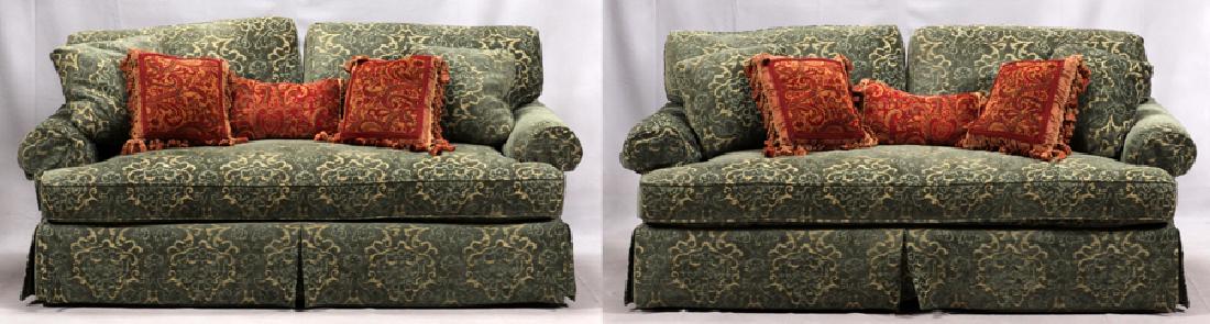 BAKER COUCHES, PAIR, H 37", W 74", D 38": BAKER COUCHES, PAIR, H 37", W 74", D 38":A pair of Baker love seat couches. Upholstered in brocatelle fabric boasting green and tan tones. Each love seat is accompanied by five pillows and a pair prot