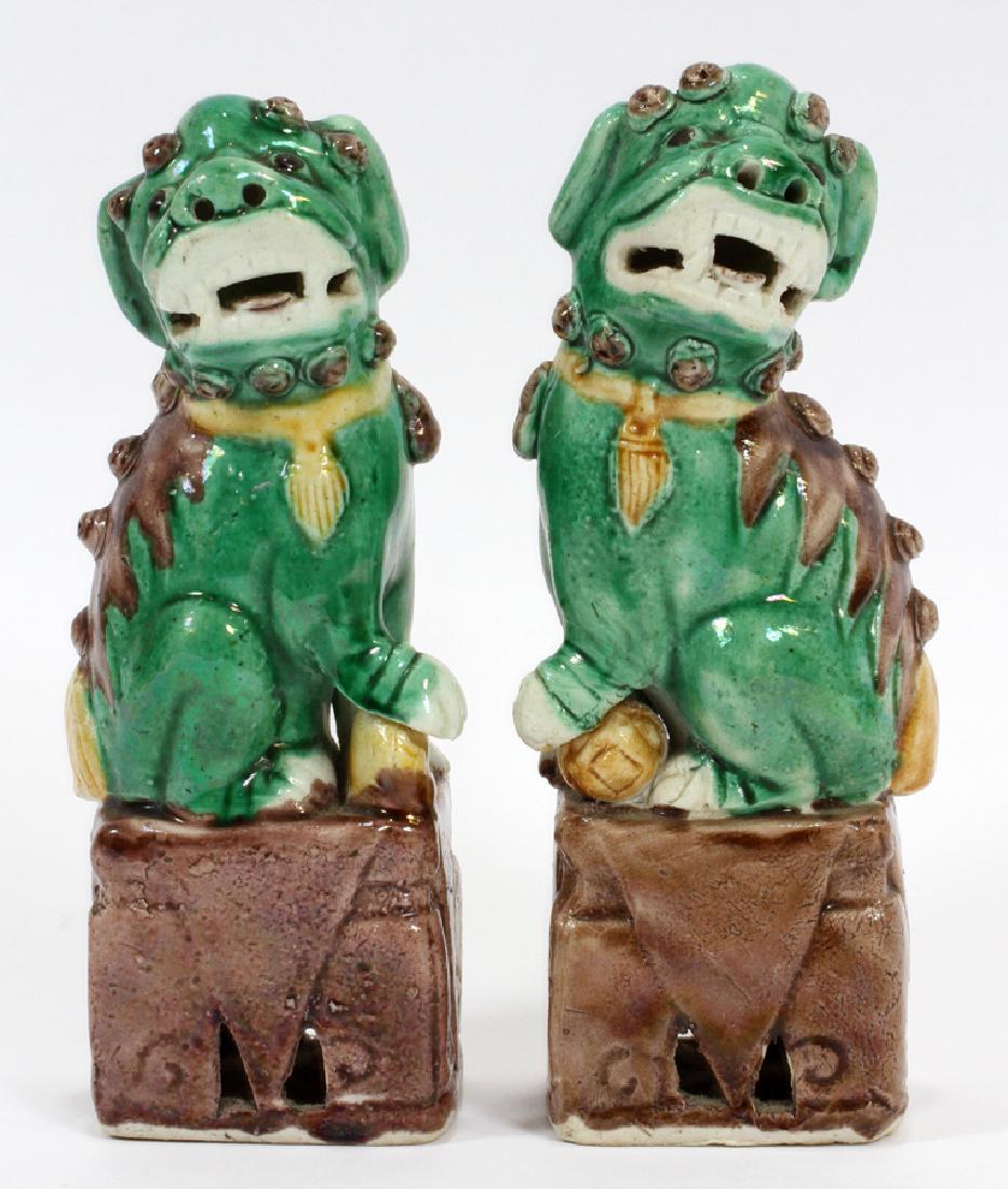 PAIR CHINESE POTTERY FOO DOGS 2 H 6.25" W 3": PAIR CHINESE POTTERY FOO DOGS 2 H 6.25" W 3" :Pair of green and brown foo dogs. Pottery, glazed in green and yellow with brown bases and accents. Highly detailed. Unmarked. Measuring approximately 6.2