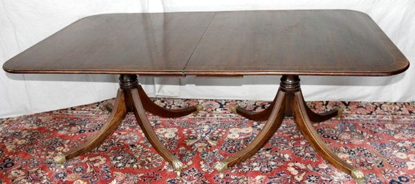 DUNCAN PHYFE STYLE MAHOGANY DINING TABLE L78": DUNCAN PHYFE STYLE, MAHOGANY DINING TABLE WITH THREE LEAVES, C. 1920, W 44", L 78":Raised on two pedestal bases, with four out-swinging legs, footed with brass claw mounts on casters. Measurements abo