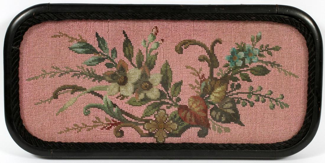 VICTORIAN PINK BEADWORK SAMPLER, H 2'', W 11'', L 22'': VICTORIAN PINK BEADWORK SAMPLER, H 2'', W 11'', L 22'' :A FRAMED BEADWORK HAVING A PINK GROUND WITH GREEN SCROLLING LEAVES AND FLOWERS, HAVING A BLACK WOVEN BORDER AND FRAMED UNDER GLASS. STANDS ON FO