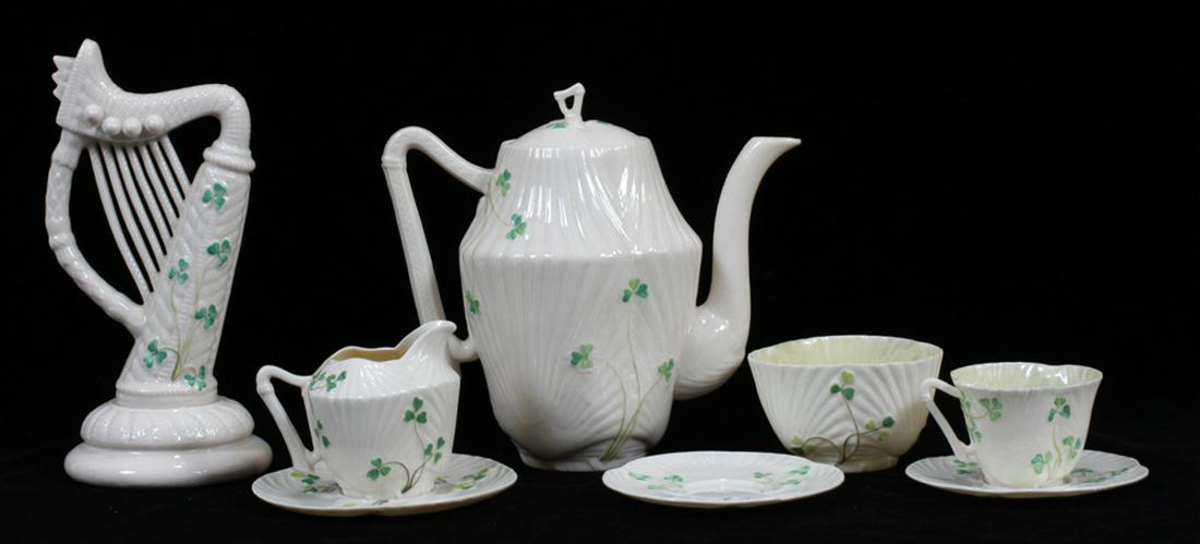 BELLEEK PORCELAIN TEAPOT AND ACCESSORIES, EIGHT PIECES: BELLEEK PORCELAIN TEAPOT AND ACCESSORIES, EIGHT PIECES :The Belleek pieces including: one each cup and saucer, open sugar , creamer with under plate, teapot and a decorative harp figurine and one sauc