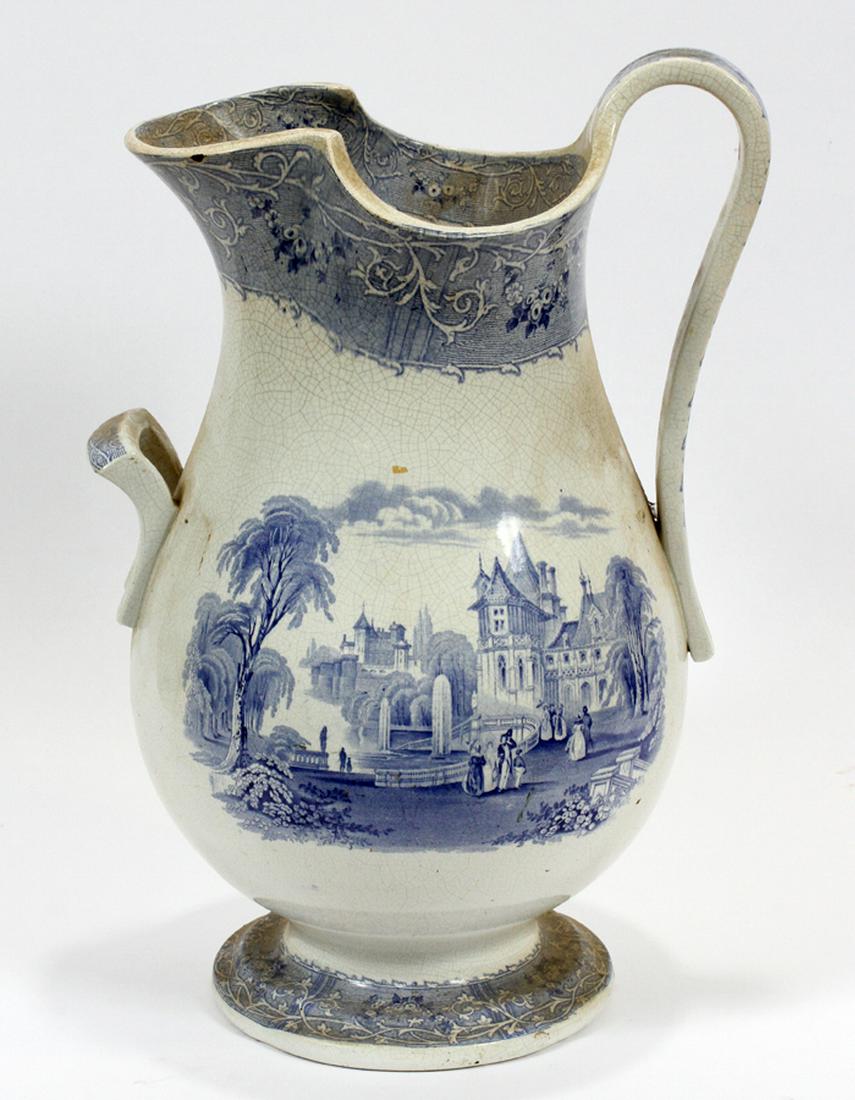 TRANSFERWARE, IRONSTONE PITCHER, 19TH C.: TRANSFERWARE, IRONSTONE PITCHER, 19TH C., H 18", W 13", D 8":A circa 19th-century transferware pitcher. Having cobalt blue motifs of 18th-century formal scenes. No distinguishable maker's mark to the 