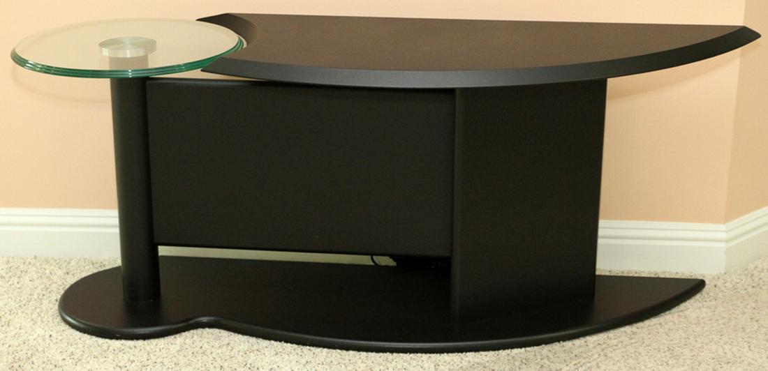 MODERN GLASS AND BLACK DECORATED CONSOLE TABLE: MODERN GLASS AND BLACK DECORATED CONSOLE TABLE, LATE 20TH C., H 20 1/2", W 16", L 52" :Modern with a free form design in black finish. Round glass top at one end. Base mimics the shape of the top surf