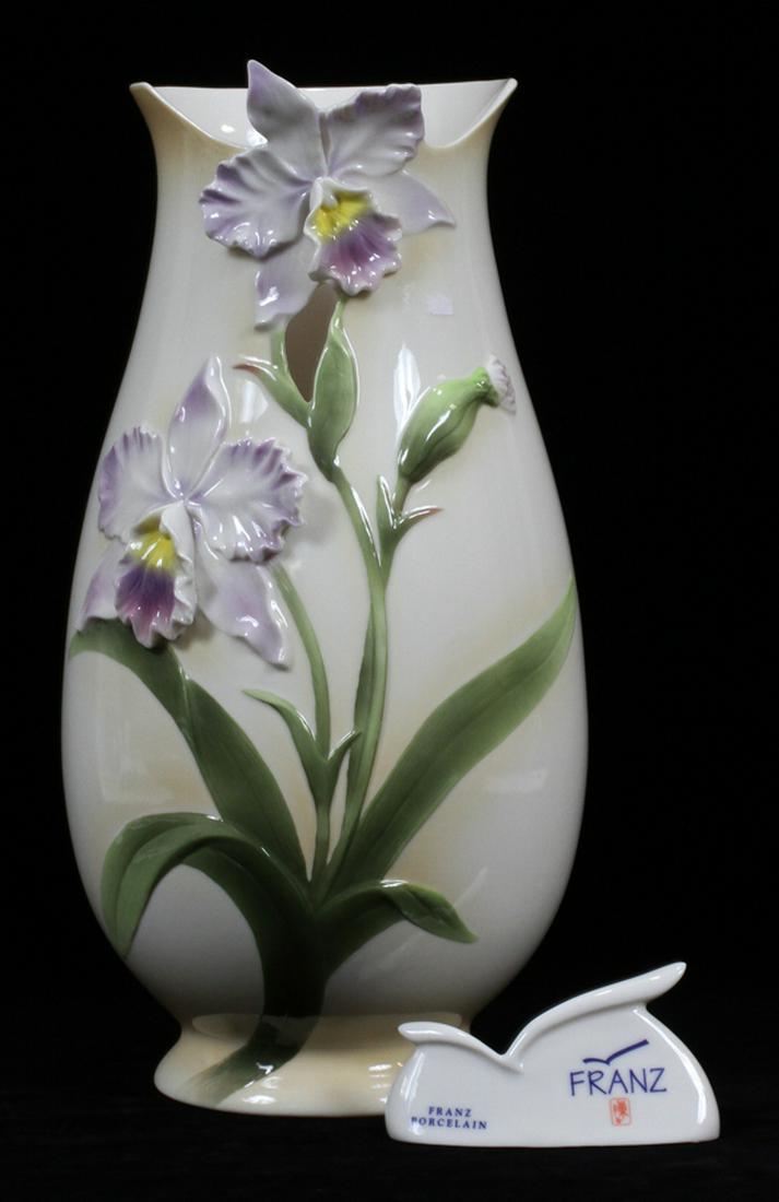 FRANZ PORCELAIN VASE, ORCHID MOTIF H 15" W 8": FRANZ PORCELAIN VASE, ORCHID MOTIF H 15" W 8" :The vase has a raised Orchid motif. From the Karner estate.