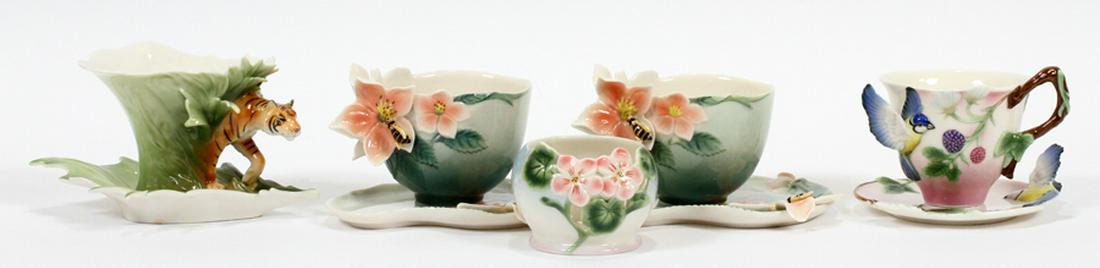 FRANZ PORCELAIN CUPS AND SAUCERS, 4 SETS: FRANZ PORCELAIN CUPS AND SAUCERS, 4 SETS, PLUS 1 TEA LIGHT, 4 PCS. H 2" - 3" :One cup in the form of a tiger with matching saucer, H 3"; one with bluebird motif and matching saucer, H 3"; two with flo