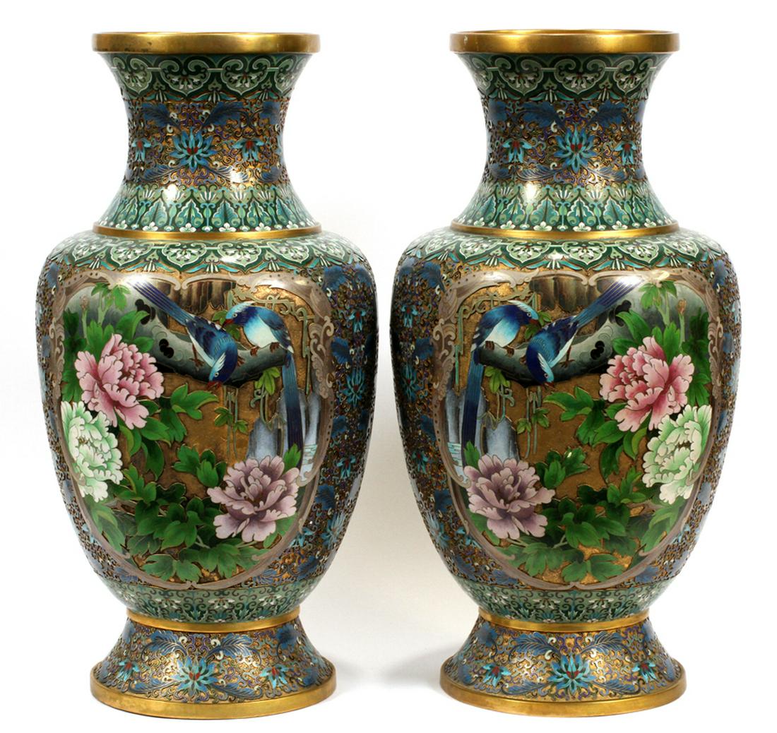CHAMPLEVE & CLOISONNE BRASS, ENAMEL URNS: CHAMPLEVE & CLOISONNE BRASS, ENAMEL URNS H 26" W 14" :A pair of champleve and cloisonne urns, having elaborate enamel patterns on brass bodies. Depicting louts flowers, blue birds, and other foliate m