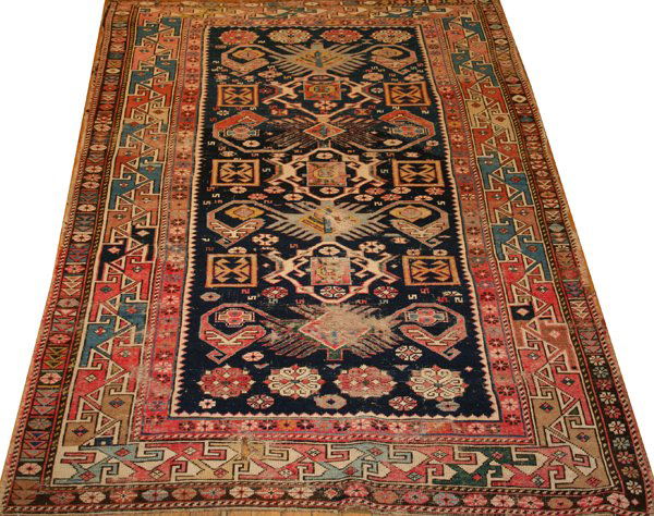 RUSSIAN ANTIQUE WOOL RUG C.1900 4'3"x6'3": RUSSIAN ANTIQUE WOOL RUG C1900 4'3" X 6'3":having seven borders, navy ground and geometric designs throughout;
