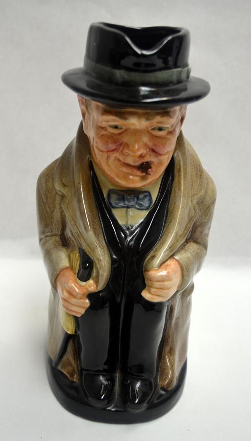 ROYAL DOULTON WINSTON CHURCHILL PORCELAIN TOBY MUG: ROYAL DOULTON WINSTON CHURCHILL, PORCELAIN TOBY MUG, H 9", W 4 1/2", D 4 1/2" :Depict Winston Churchill with a walking stick, overcoat, black had and smoking a cigar.