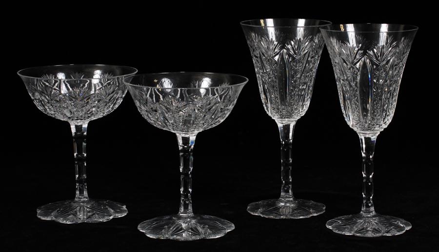 BACCARAT FRANCE CRYSTAL CHAMPAGNE & WINE GLASSES: BACCARAT FRANCE CRYSTAL "CONDE" 9 CHAMPAGNE & 8 WINE GLASSES H 4.6" TO 8.12" :Having petal form bases. Engraved with Conde pattern. Seventeen pieces.