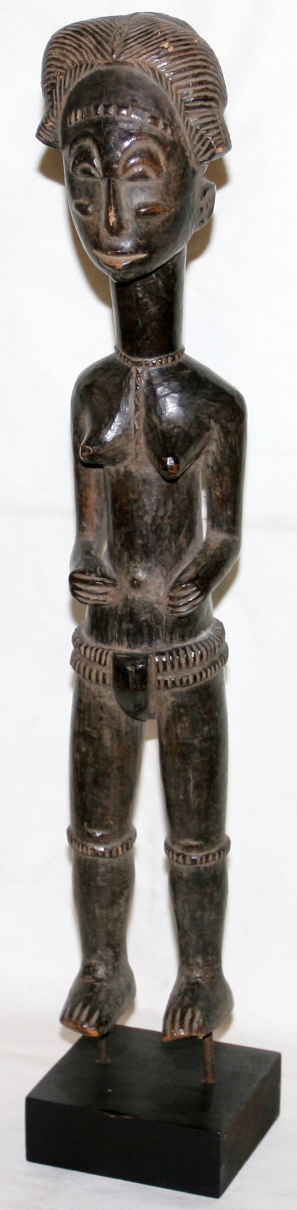 AFRICAN BAULE WOOD FEMALE FIGURE ON WOOD BASE: AFRICAN BAULE WOOD FEMALE FIGURE RAISED ON WOOD BASE, H 21": From the Estate of Douglas Crary, Ann Arbor, Mi