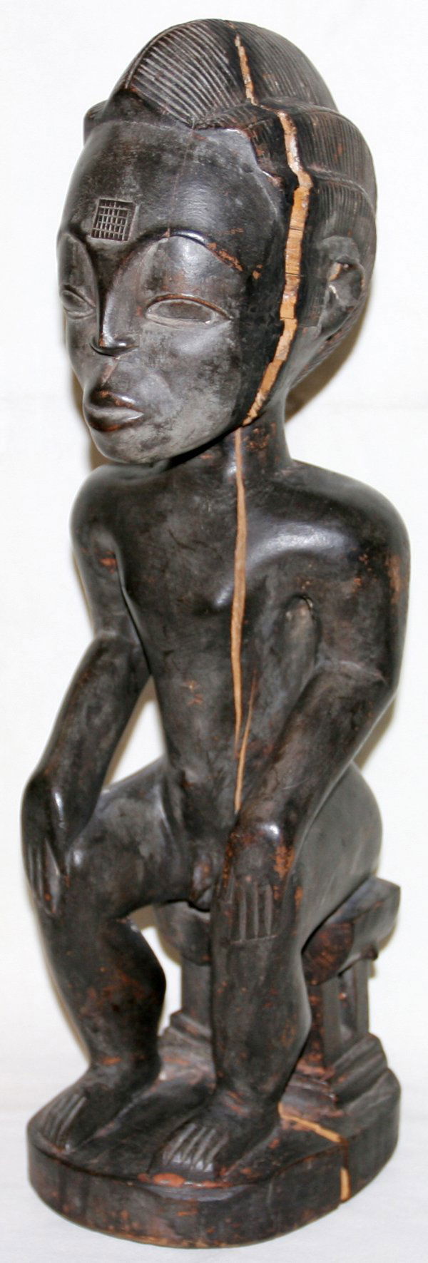AFRICAN BAULE WOODEN MALE FIGURE SEATED H 18": AFRICAN BAULE WOODEN MALE FIGURE SEATED ON STOOL H 18":Marked "Baoule" on weathered bottom. From the Estate of Douglas Crary, Ann Arbor, Mi.