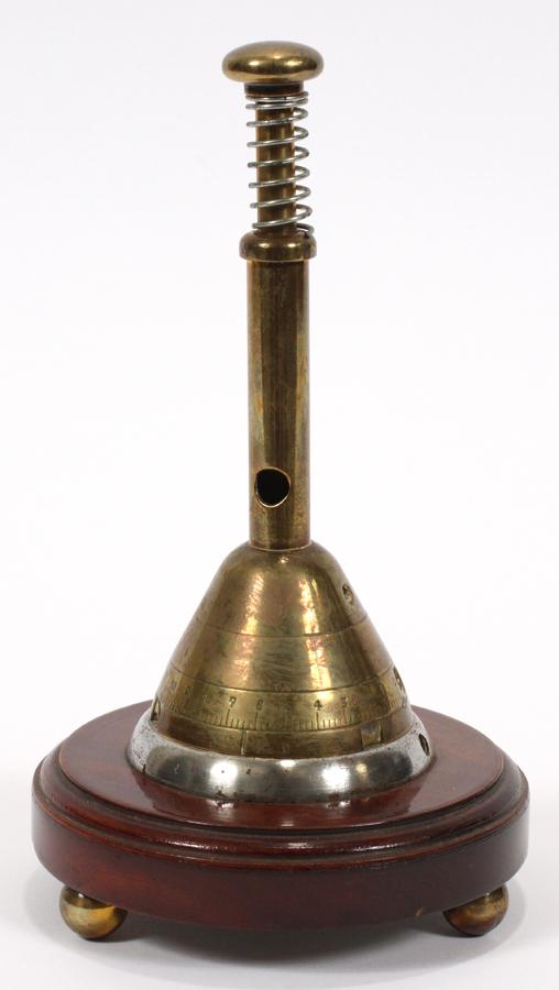 WW 1 ERA, BRASS AND PLATED STEEL, CIGAR CUTTER: WW 1 ERA, BRASS AND PLATED STEEL, CIGAR CUTTER, C1917, H 8", DIA 4 1/2" Made from a brass artillery mortar shell fuse mounted on a round wood base with brass ball feet. A cylindrical brass shaft mount