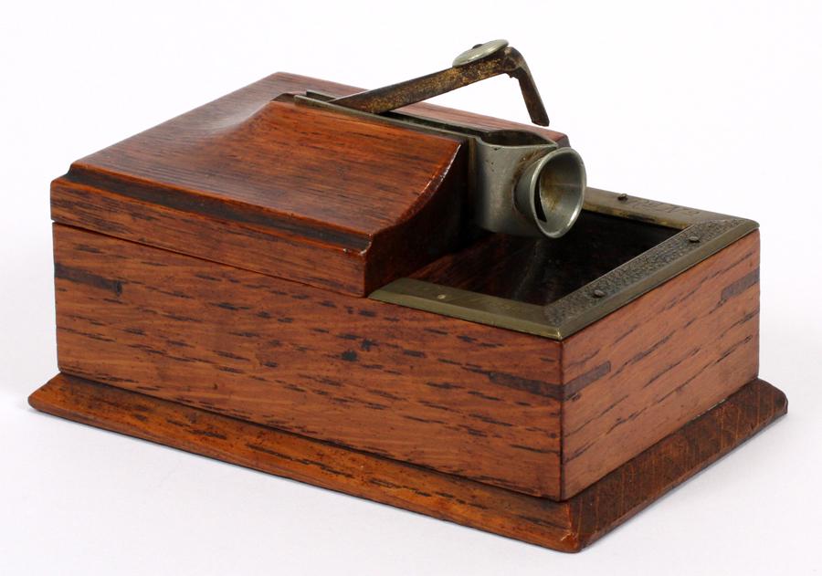 ENGLISH OAK, BRASS AND NICKEL CIGAR BOX AND CUTTER: ENGLISH, OAK, BRASS AND NICKEL, CIGAR BOX AND CUTTER, C1895, H 2.25", L 4", RD NO. 223291/697 (1895) Having an oak box for cigar storage with the lid housing the cutter, which is of nickel. The brass 