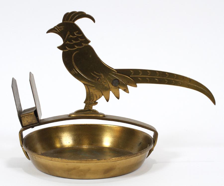 GERMAN ART DECO PHEASANT FORM BRASS CIGAR CUTTER: GERMAN, ART DECO, PHEASANT FORM, BRASS CIGAR CUTTER AND ASHTRAY, C1930, H 7", L 9" Depicts a pheasant mounted on an ashtray with a matchbox holder. All of gilt brass. Bird mark inside a triangle on th