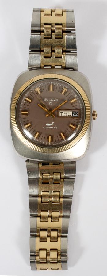 BULOVA STAINLESS STEEL & GOLD FILLED WATCH: BULOVA STAINLESS STEEL, 14 & 10KT GOLD FILLED GENTLEMAN'S WATCH, L 4 3/4"Having a stainless steel and 14kt gold filled trimmed band, set in a stainless steel case with 10kt gold filled bezel ring, aut