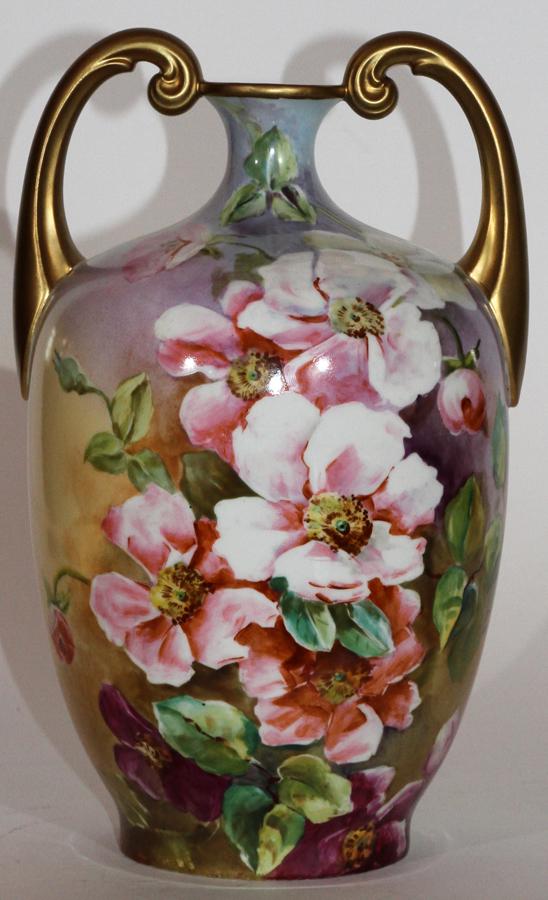 J.P. LIMOGES, HAND-PAINTED PORCELAIN VASE: J.P. LIMOGES, HAND-PAINTED PORCELAIN VASE, H 13.5", DIA 8"A J.P. Limoges hand-painted porcelain vase. This piece offers scroll form handles, gilt accents and pink peony blossoms. Artist's signature "D