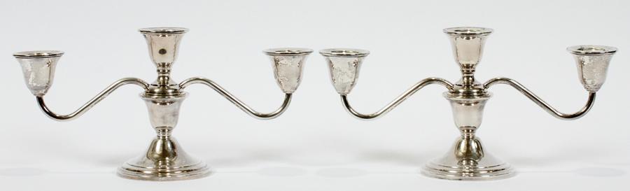 NEWPORT STERLING THREE-LIGHT CANDELABRA, PAIR: NEWPORT STERLING THREE-LIGHT CANDELABRA, PAIR, W 11"Each sterling silver three-light candelabrum converts to a single-light and is raised on a circular weighted base. Measures H.5 1/2", W.11 1/2".